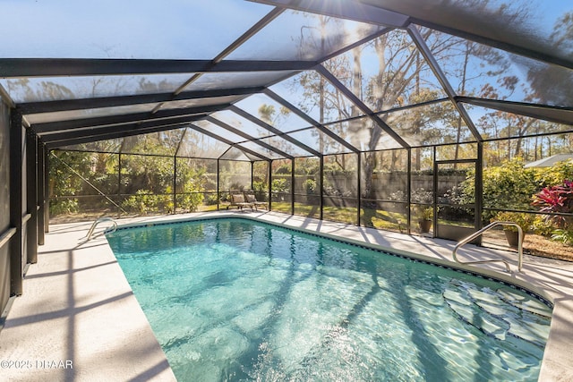 outdoor pool featuring a patio area and a lanai