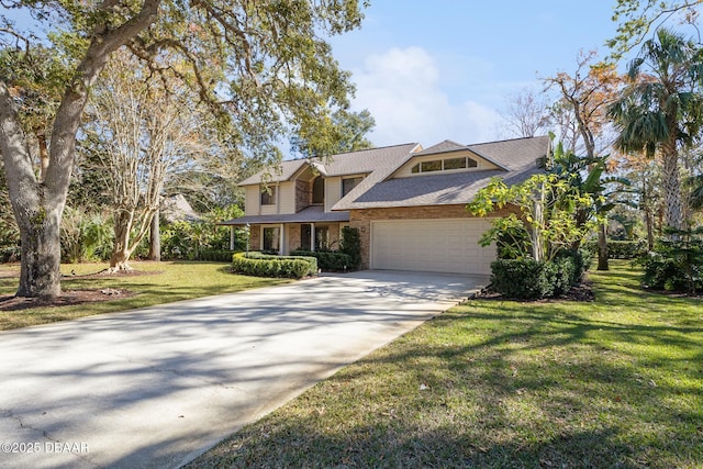 view of front of house featuring a garage, driveway, a front lawn, and brick siding