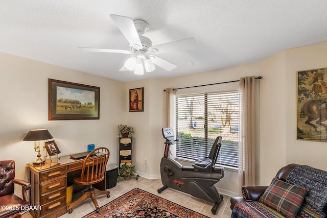 office with light tile patterned flooring, ceiling fan, a textured ceiling, and baseboards