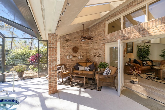 view of patio with glass enclosure, ceiling fan, and outdoor lounge area