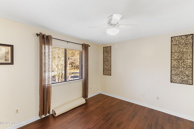 empty room featuring ceiling fan, a textured ceiling, baseboards, and wood finished floors