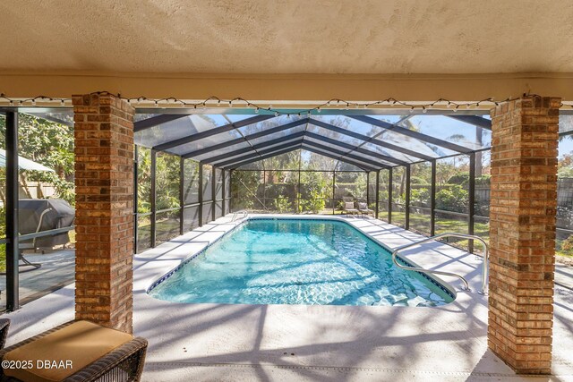 outdoor pool featuring a patio area, a lanai, and a grill