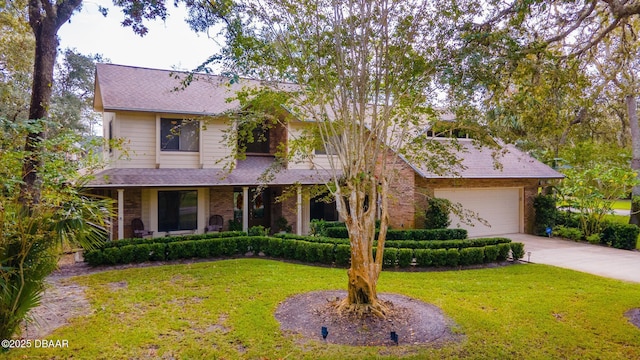 view of front facade featuring an attached garage, concrete driveway, brick siding, and a front yard