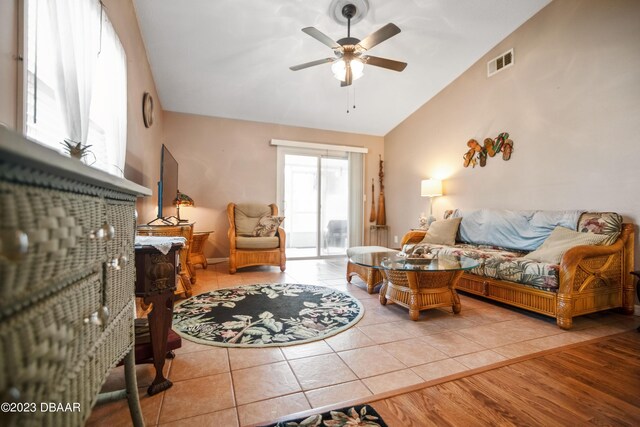 2835 Nordman Ave, New Smyrna Beach, FL 32168 - living area with lofted ceiling, a ceiling fan, and tile patterned flooring