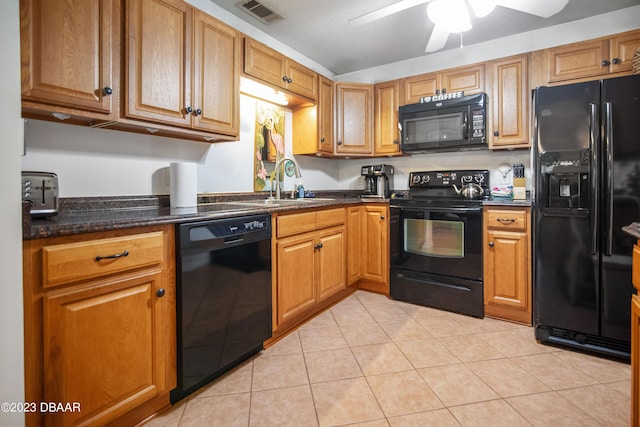 2835 Nordman Ave, New Smyrna Beach, FL 32168 - kitchen with black appliances, a sink, a ceiling fan, light tile patterned floors, and brown cabinetry