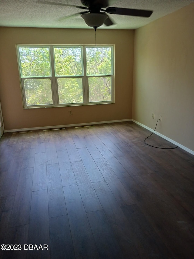 1401 S Palmetto Ave Unit 811, Daytona Beach, FL 32114 - unfurnished room with a ceiling fan, wood finished floors, baseboards, and a textured ceiling