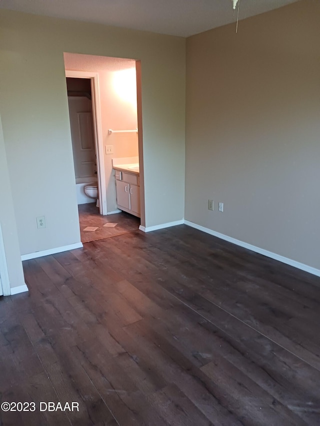 empty room with dark hardwood / wood-style flooring