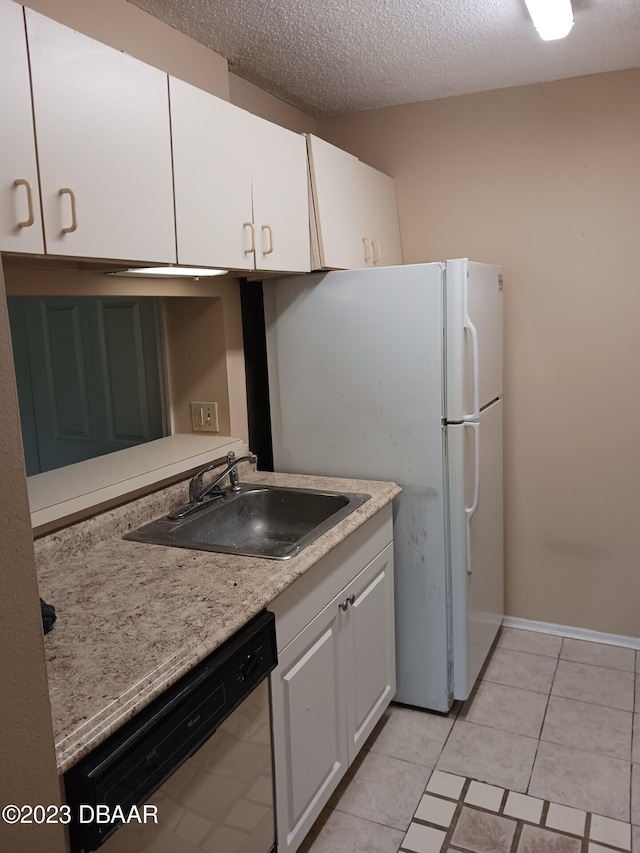 kitchen featuring white cabinets, a textured ceiling, stainless steel dishwasher, and sink