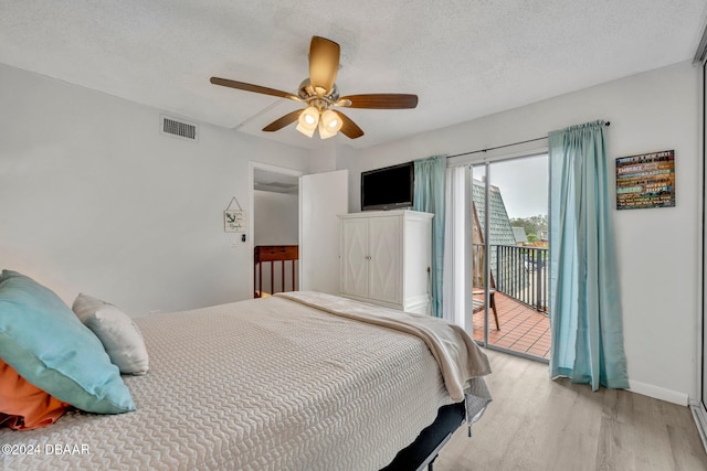 bedroom featuring access to exterior, light hardwood / wood-style flooring, a textured ceiling, and ceiling fan