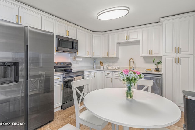 kitchen with light countertops, appliances with stainless steel finishes, and white cabinetry