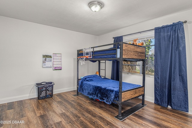 bedroom with baseboards and wood finished floors