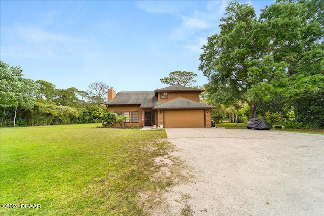 view of front of property featuring a garage and a front lawn