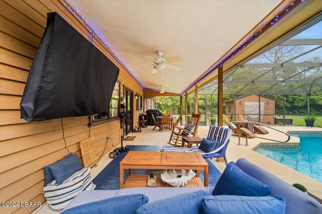 view of patio with glass enclosure, outdoor lounge area, and ceiling fan