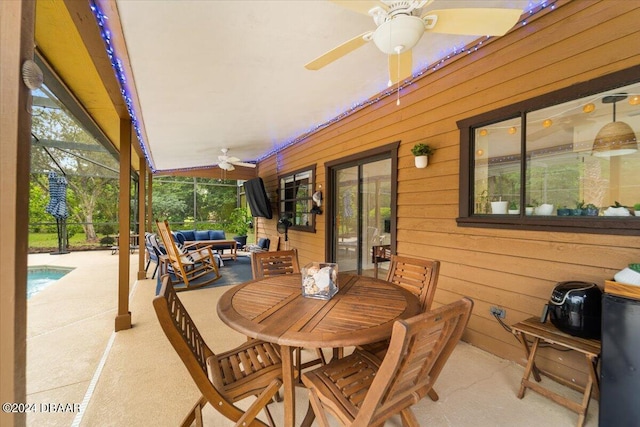 view of patio / terrace featuring glass enclosure and ceiling fan