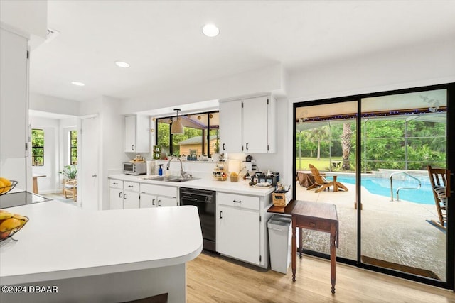 kitchen featuring black appliances, a healthy amount of sunlight, and light hardwood / wood-style flooring