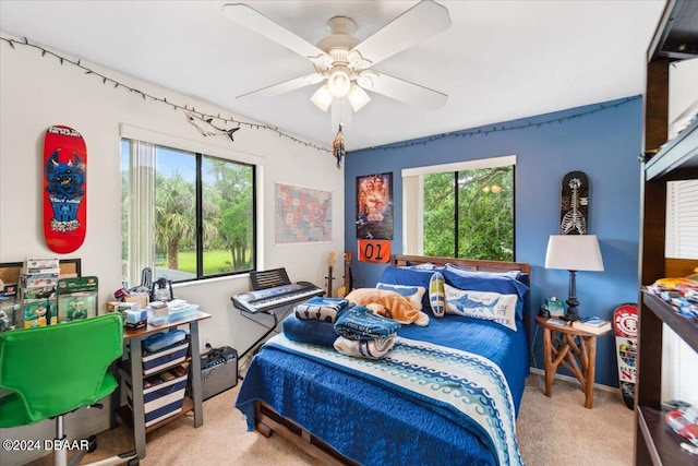 carpeted bedroom with ceiling fan and multiple windows