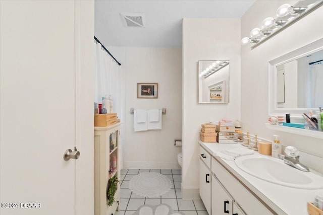 bathroom featuring tile patterned flooring, vanity, and toilet