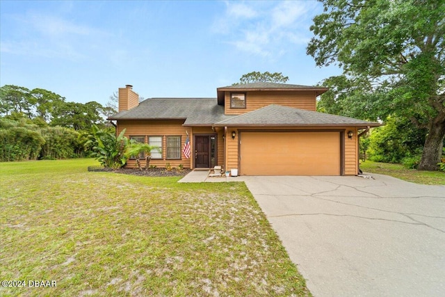 view of front of property with a front lawn and a garage