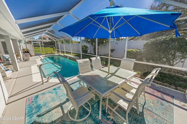 view of swimming pool featuring a lanai and a patio area