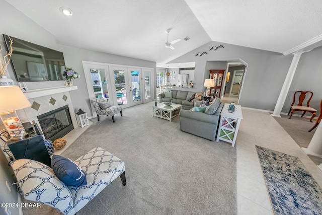 carpeted living room with ceiling fan, french doors, and vaulted ceiling