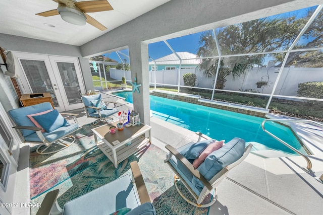 view of swimming pool with ceiling fan and french doors