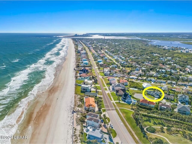 drone / aerial view with a beach view and a water view