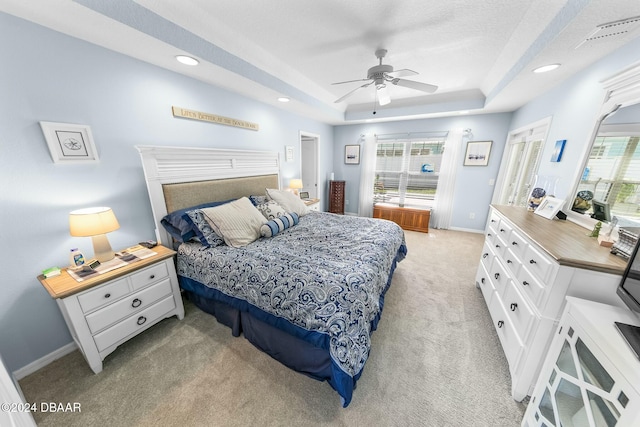 bedroom with light colored carpet, multiple windows, and ceiling fan