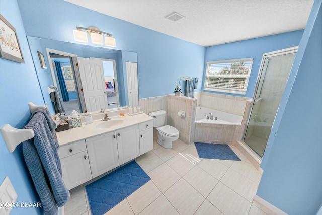 full bathroom featuring tile patterned floors, vanity, a textured ceiling, plus walk in shower, and toilet