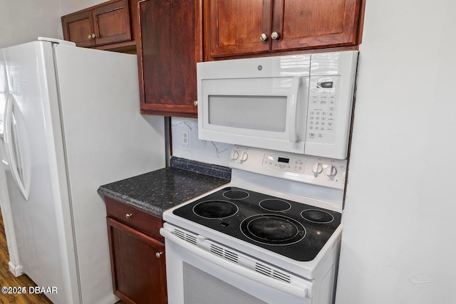 kitchen featuring white appliances and backsplash