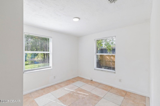 empty room with baseboards and plenty of natural light