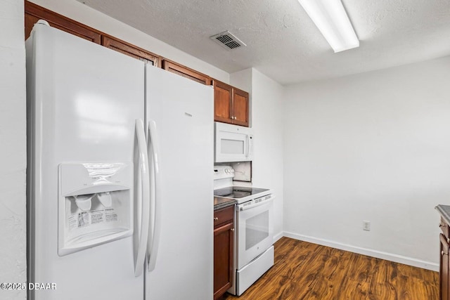 kitchen featuring visible vents, a textured ceiling, white appliances, baseboards, and dark wood-style flooring