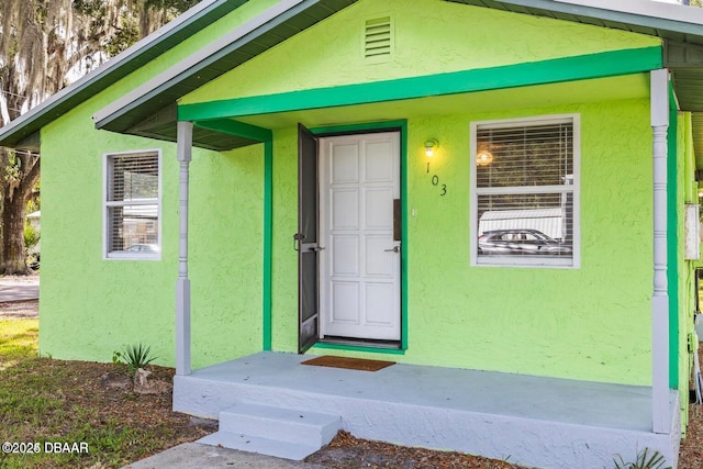 property entrance featuring stucco siding