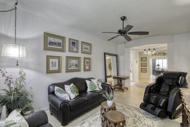 47 Abacus Ave, Ormond Beach, FL 32174 - living room featuring a chandelier, a ceiling fan, baseboards, arched walkways, and light tile patterned flooring