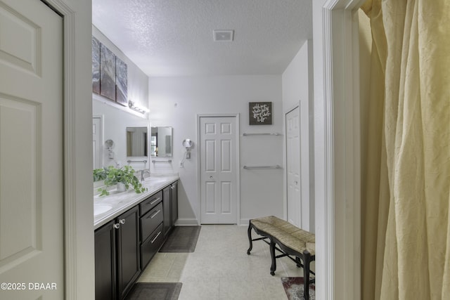 47 Abacus Ave, Ormond Beach, FL 32174 - full bathroom featuring double vanity and a textured ceiling