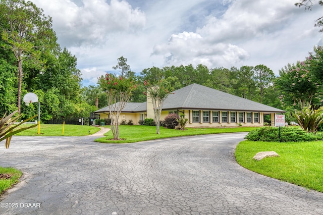 47 Abacus Ave, Ormond Beach, FL 32174 - single story home featuring curved driveway, a front yard, a chimney, and view of wooded area