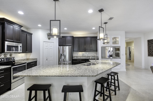 47 Abacus Ave, Ormond Beach, FL 32174 - kitchen featuring stainless steel appliances, a sink, a breakfast bar, a spacious island, and recessed lighting