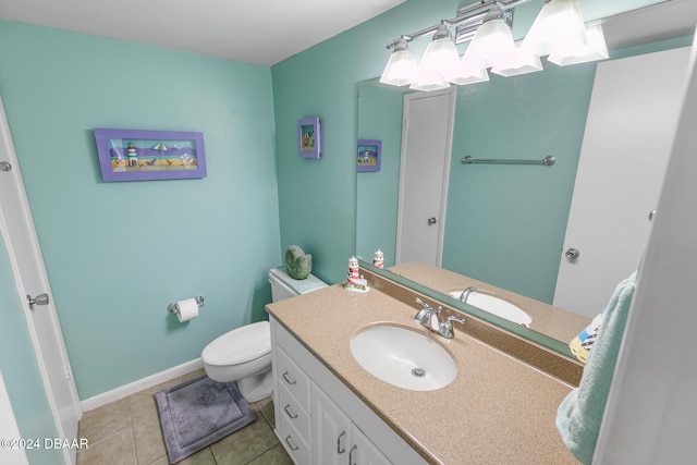 bathroom with tile patterned flooring, vanity, and toilet