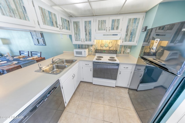 kitchen with sink, white cabinets, white appliances, and light tile patterned floors