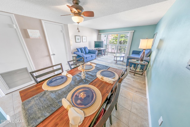 dining space with ceiling fan, light hardwood / wood-style flooring, and a textured ceiling