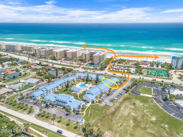 drone / aerial view featuring a water view and a beach view