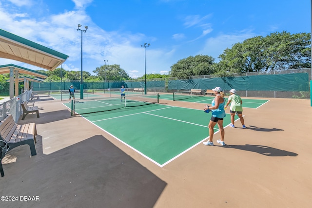 view of tennis court featuring basketball court