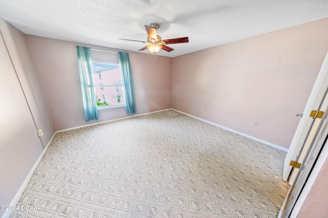 spare room featuring a textured ceiling, light colored carpet, and ceiling fan