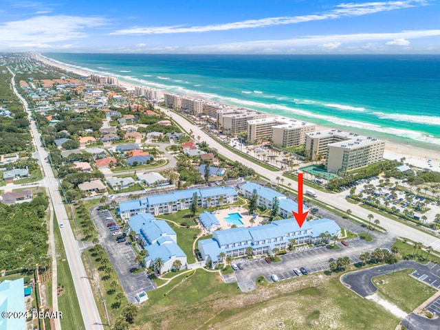 drone / aerial view with a beach view and a water view