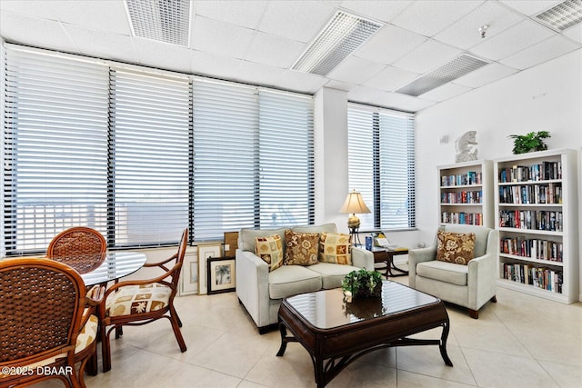 interior space featuring light tile patterned floors, visible vents, and a drop ceiling