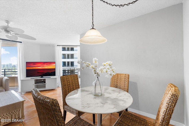 dining area featuring light tile patterned floors, a textured ceiling, and ceiling fan
