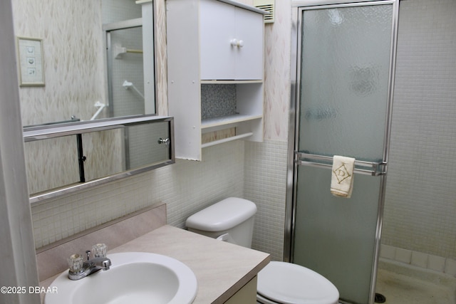 bathroom with a shower with door, vanity, decorative backsplash, and toilet