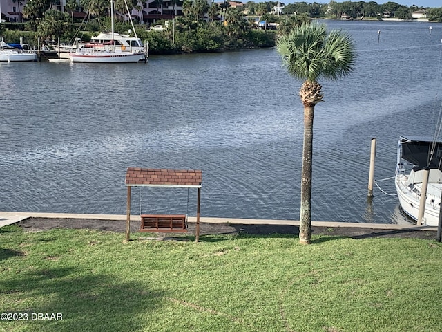 view of dock featuring a yard and a water view