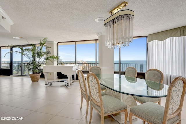 2425 S Atlantic Ave Unit 202, Daytona Beach, FL 32118 - tiled dining room featuring expansive windows, a textured ceiling, a chandelier, and a water view