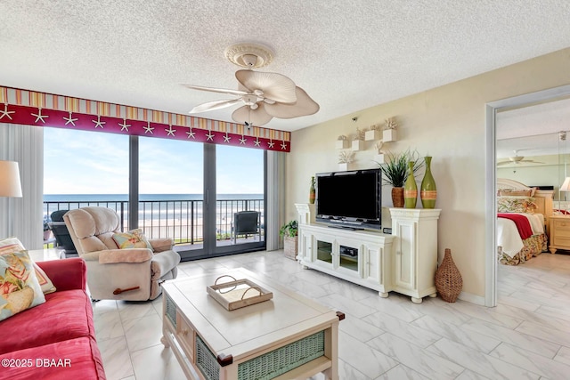 2425 S Atlantic Ave Unit 202, Daytona Beach, FL 32118 - living room with a ceiling fan, light marble finish flooring, and a textured ceiling