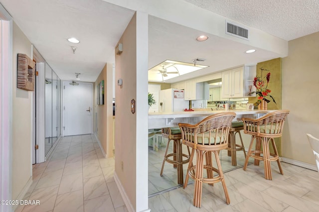 2425 S Atlantic Ave Unit 202, Daytona Beach, FL 32118 - dining room with light marble finish floors, recessed lighting, a ceiling fan, and a textured ceiling